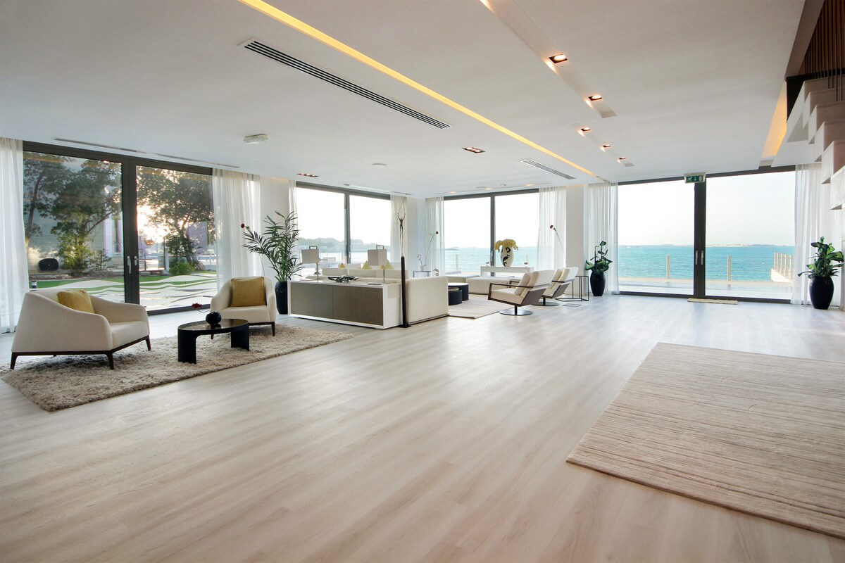 Expansive minimalist living room with uninterrupted sea views