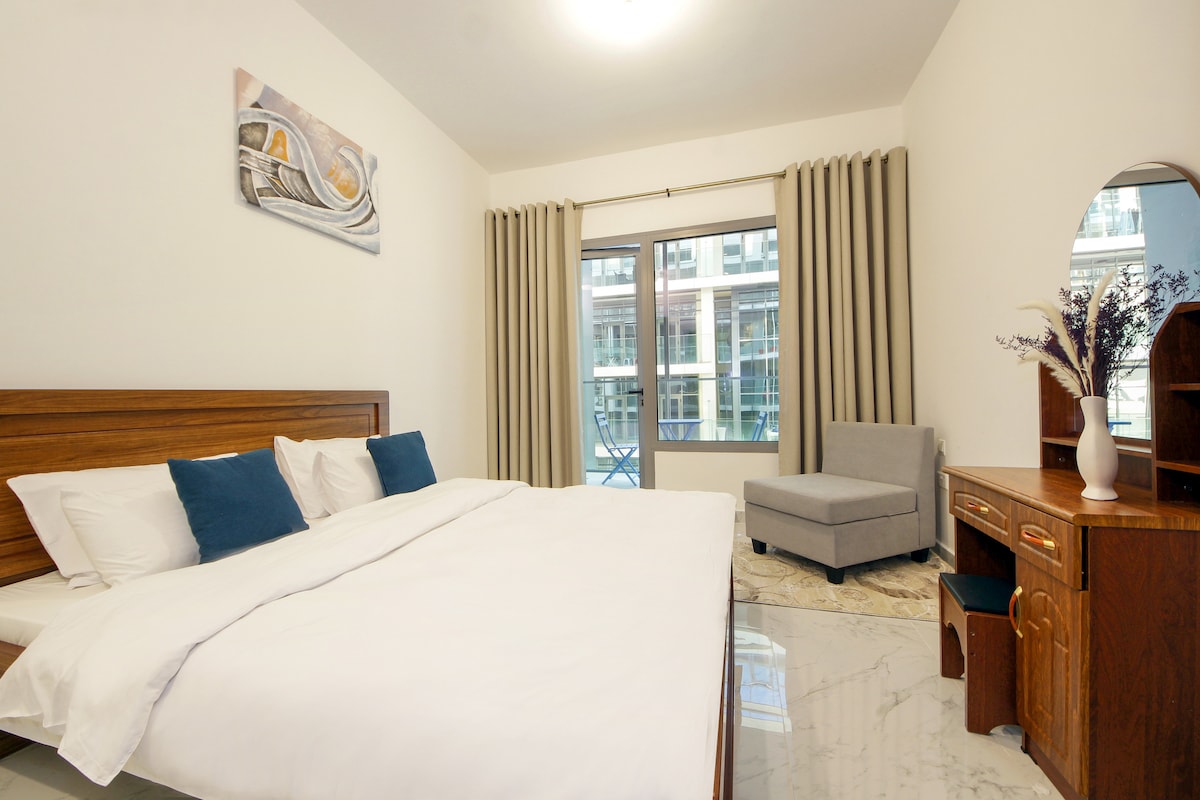 Neutral bedroom with wood accents and balcony light