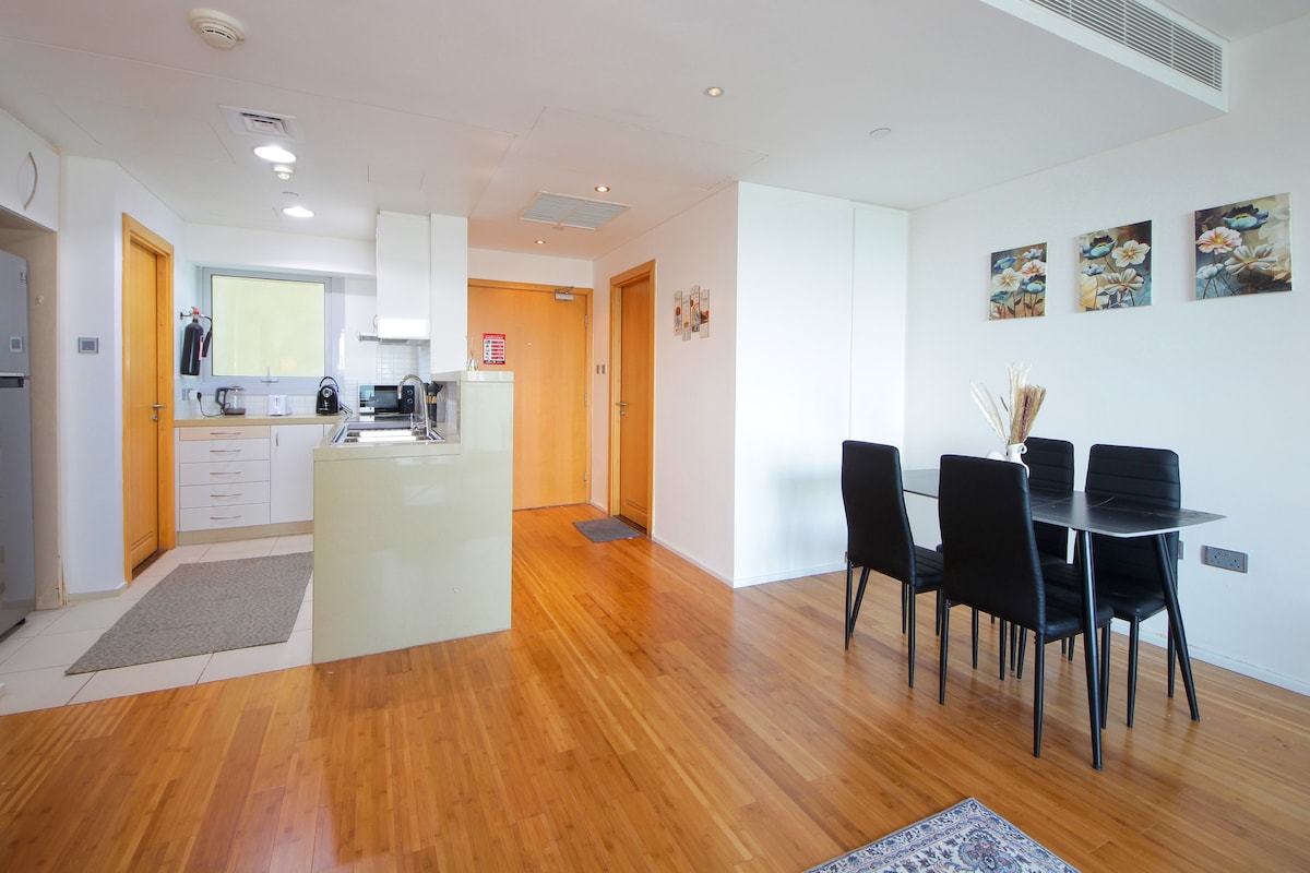 Open kitchen and dining area with warm timber flooring